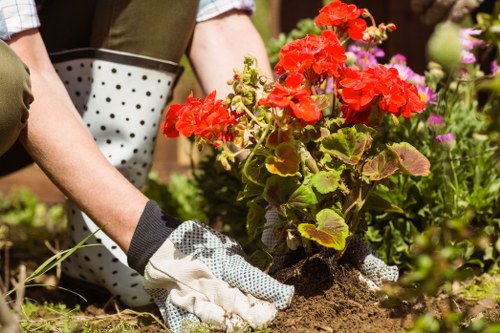 Garden maintenance worker following safe tool and site practices